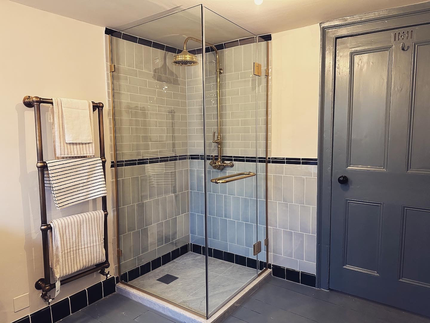 Bespoke shower glass enclosure constructed using satin brass components and hardware